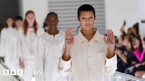 Model stages silent protest on Gucci catwalk over 'straitjacket